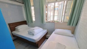 A hotel room with two beds, a window with curtains, and a view of the outside. - Tempo Inn West Kowloon HSR Station (Kowloon)