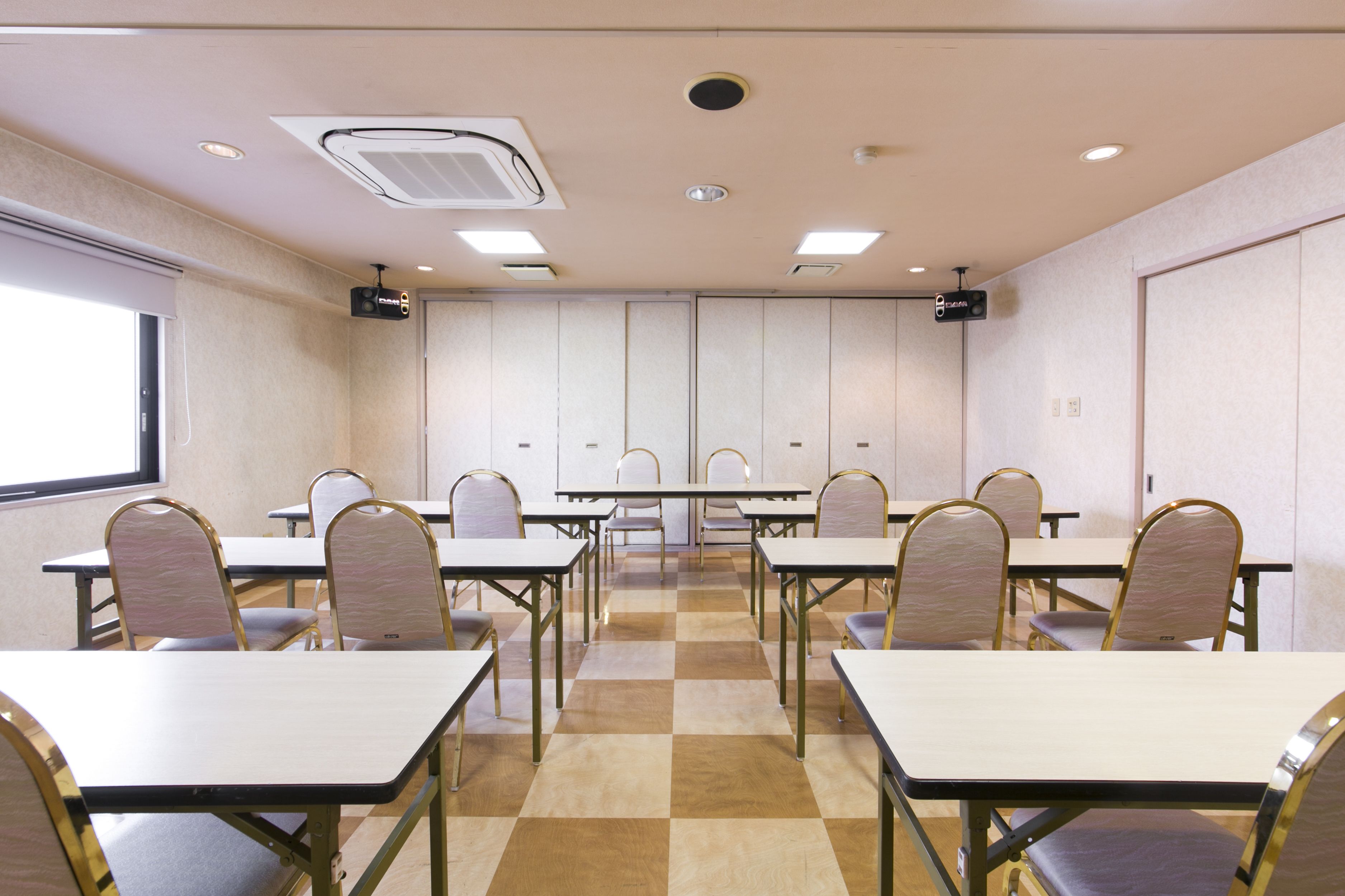 A conference room with tables and chairs arranged for meetings.