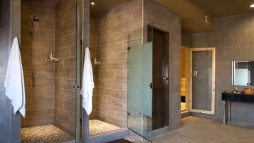 Spacious bathroom with walk-in shower, separate shower stall, and vanity area.