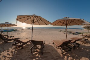 Private beach, white sand, sun loungers, beach umbrellas