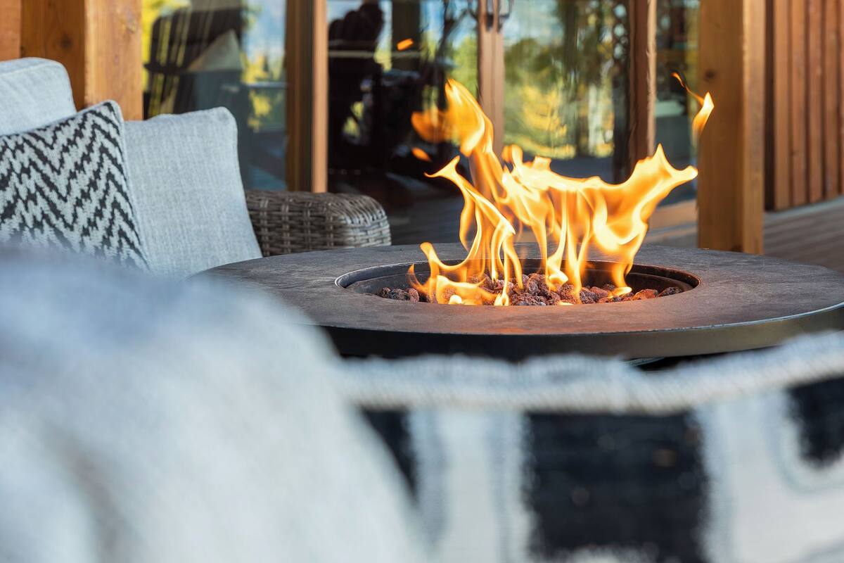 A modern outdoor seating area with a fire feature.