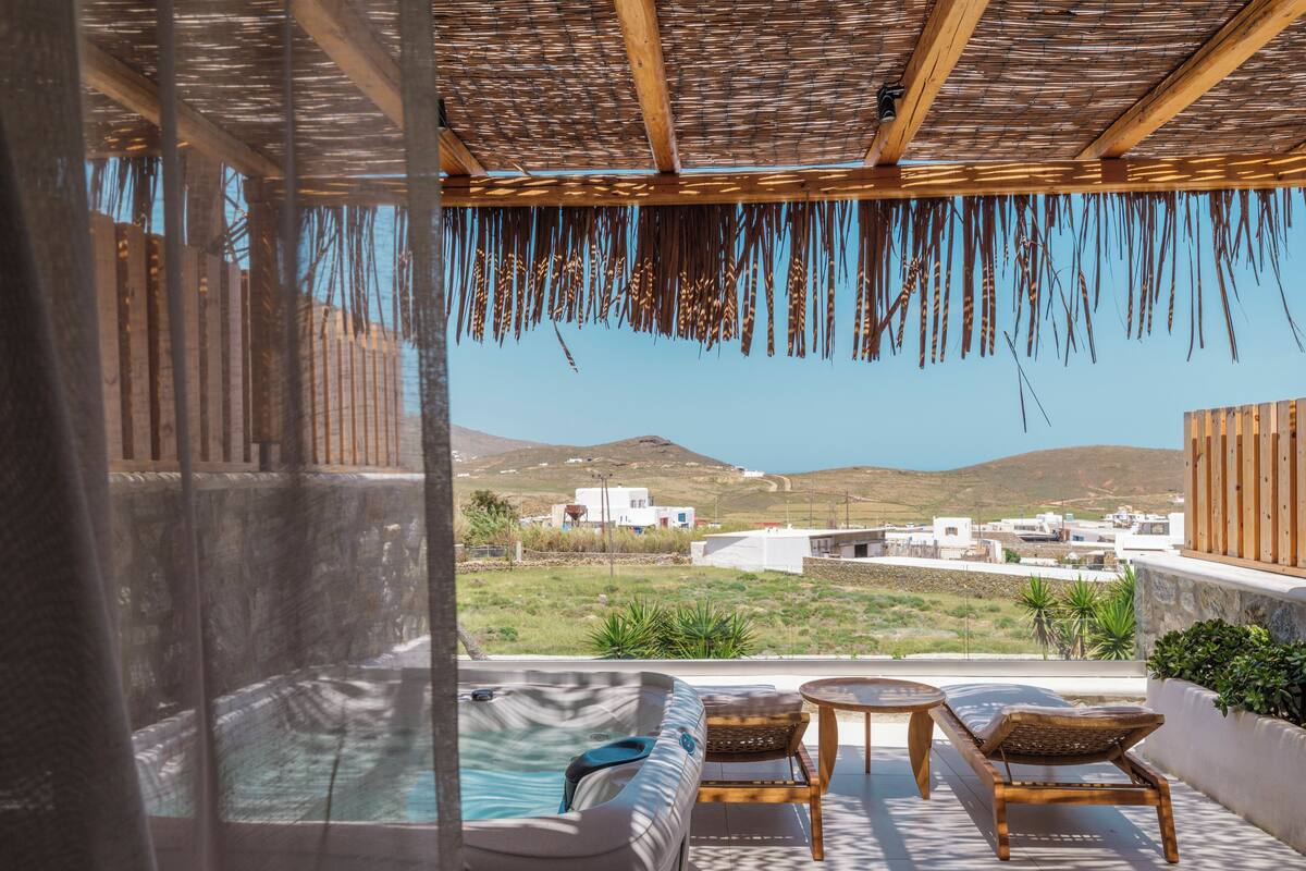 A hot tub with a view of a coastal landscape.