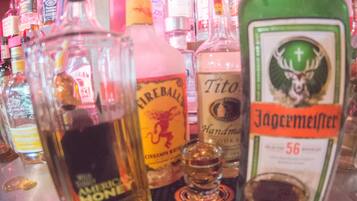 A bar with various liquor bottles and a sign reading "Rich & Ern".
