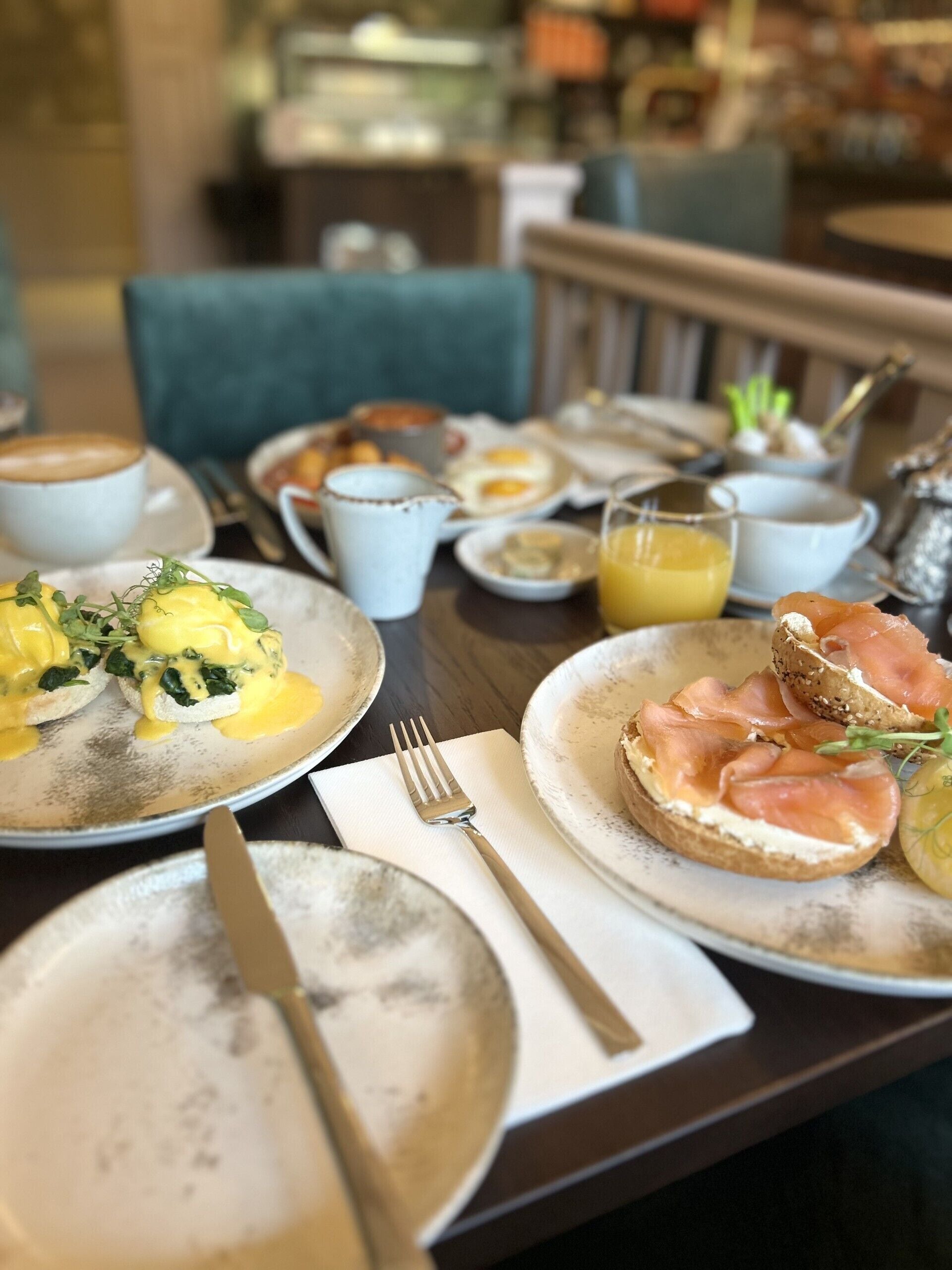 A breakfast setting with eggs, toast, and a coffee cup on a table.