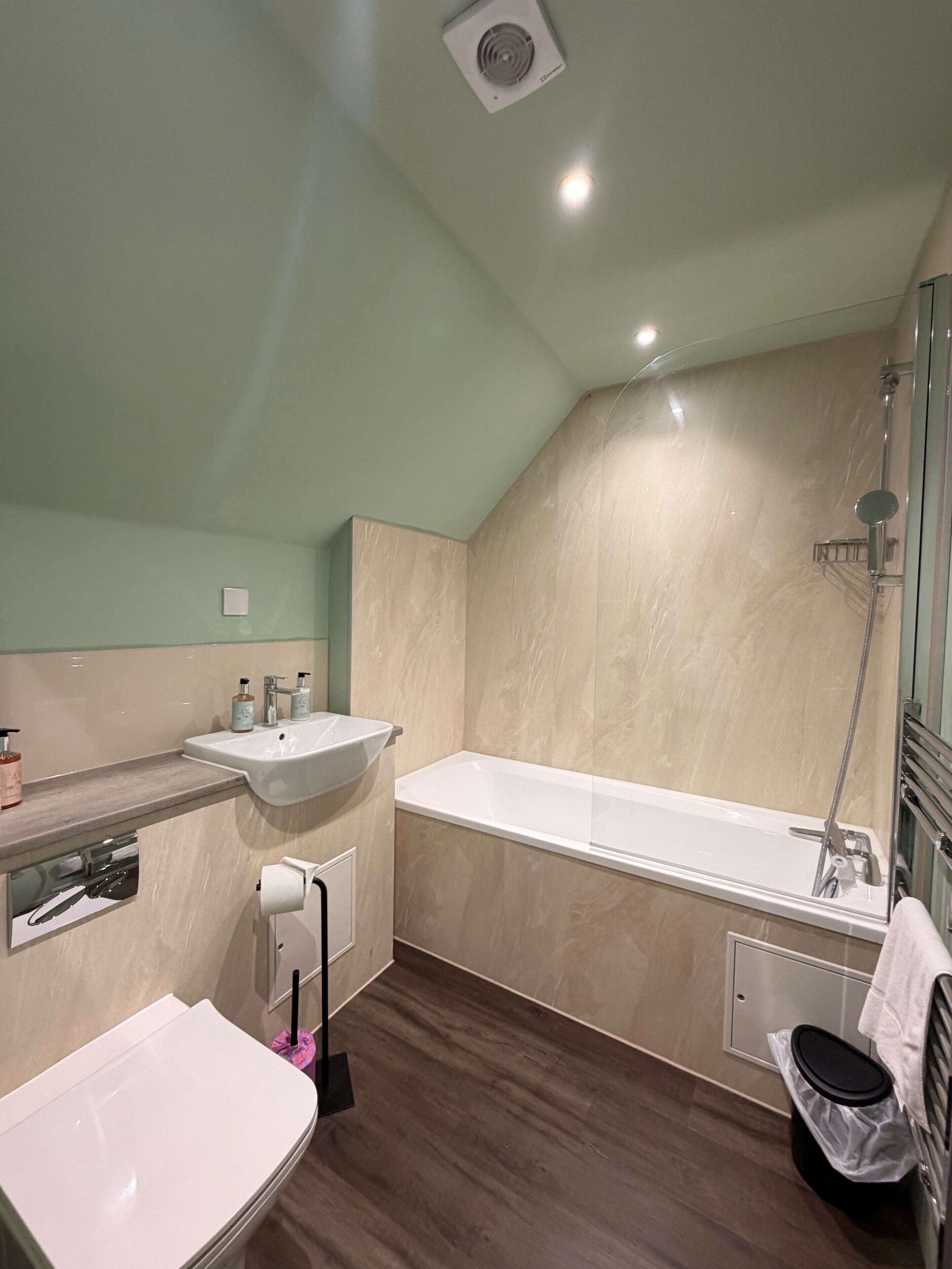 A bathroom with a sink, toilet, bathtub, and shower.