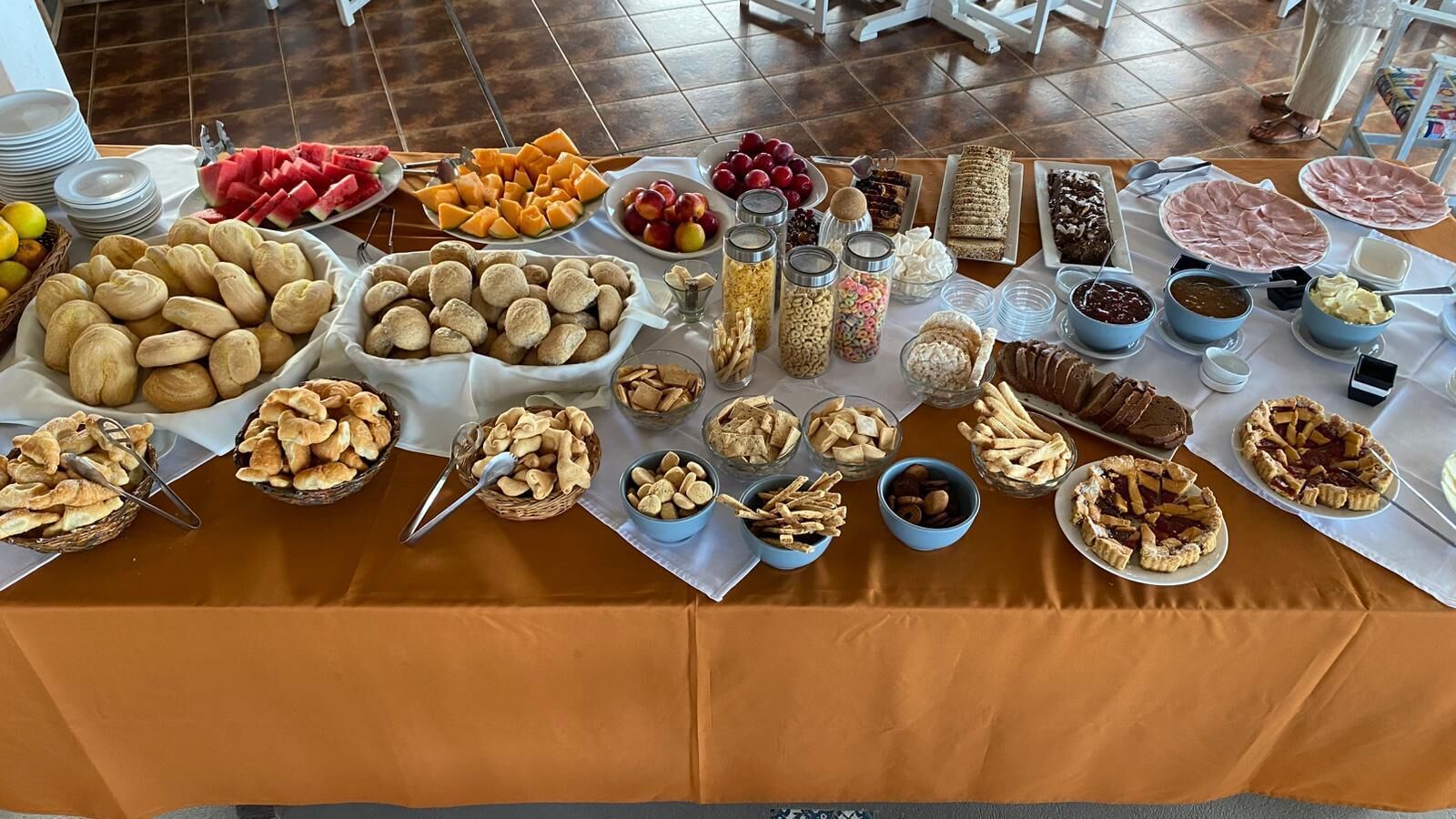 A buffet table with various food items and desserts.