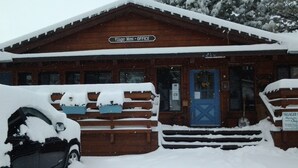 A wooden building with a sign reading "Villager Motel - Office". - June Lake Villager (June Lake)
