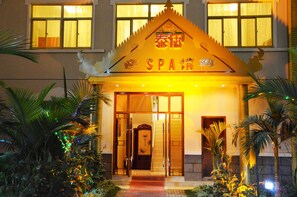 A spa hotel entrance with a traditional architectural design, featuring a prominent entrance and a signboard. - Sogecoa Zambia Golden Peacock Hotel (Lusaka)
