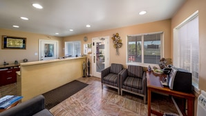 A spacious living area with a kitchen, a dining table, and a seating area.