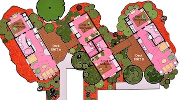 A floor plan of a building with two units, each containing a bedroom and a living area, separated by a deck.