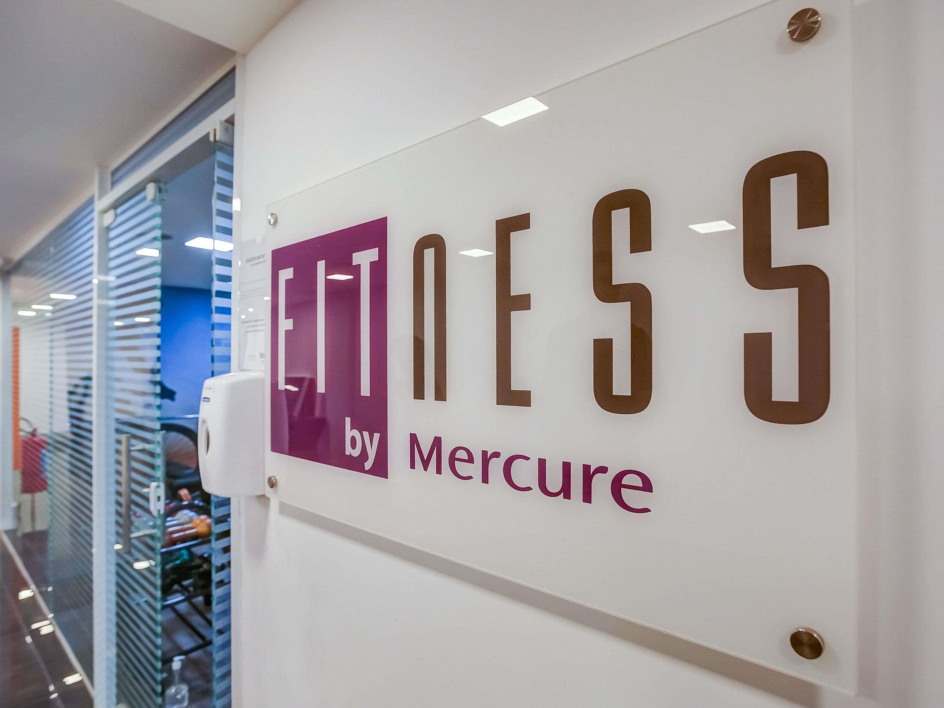 A sign with the text 'ELT by Mercure' on a white wall.