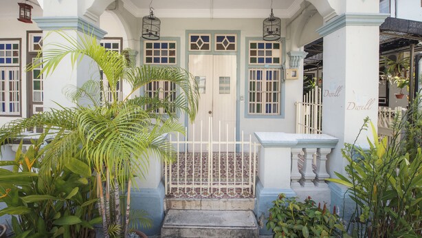 A white building with blue trim and a tiled entrance. - Dwell by Palanquinn (George Town)