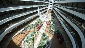 A multi-level atrium with a central courtyard, multiple balconies, and seating areas.