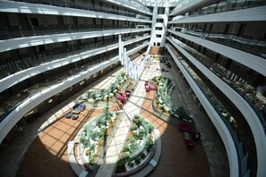 A multi-level atrium with a central courtyard, multiple balconies, and seating areas.