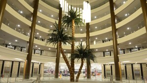A multi-level atrium with palm trees, glass railings, and modern lighting fixtures. - Green Nature Diamond Hotel (Marmaris)