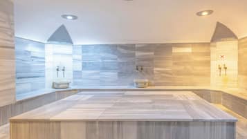 Bathroom features a large sink area with two wall-mounted faucets and a separate basin.