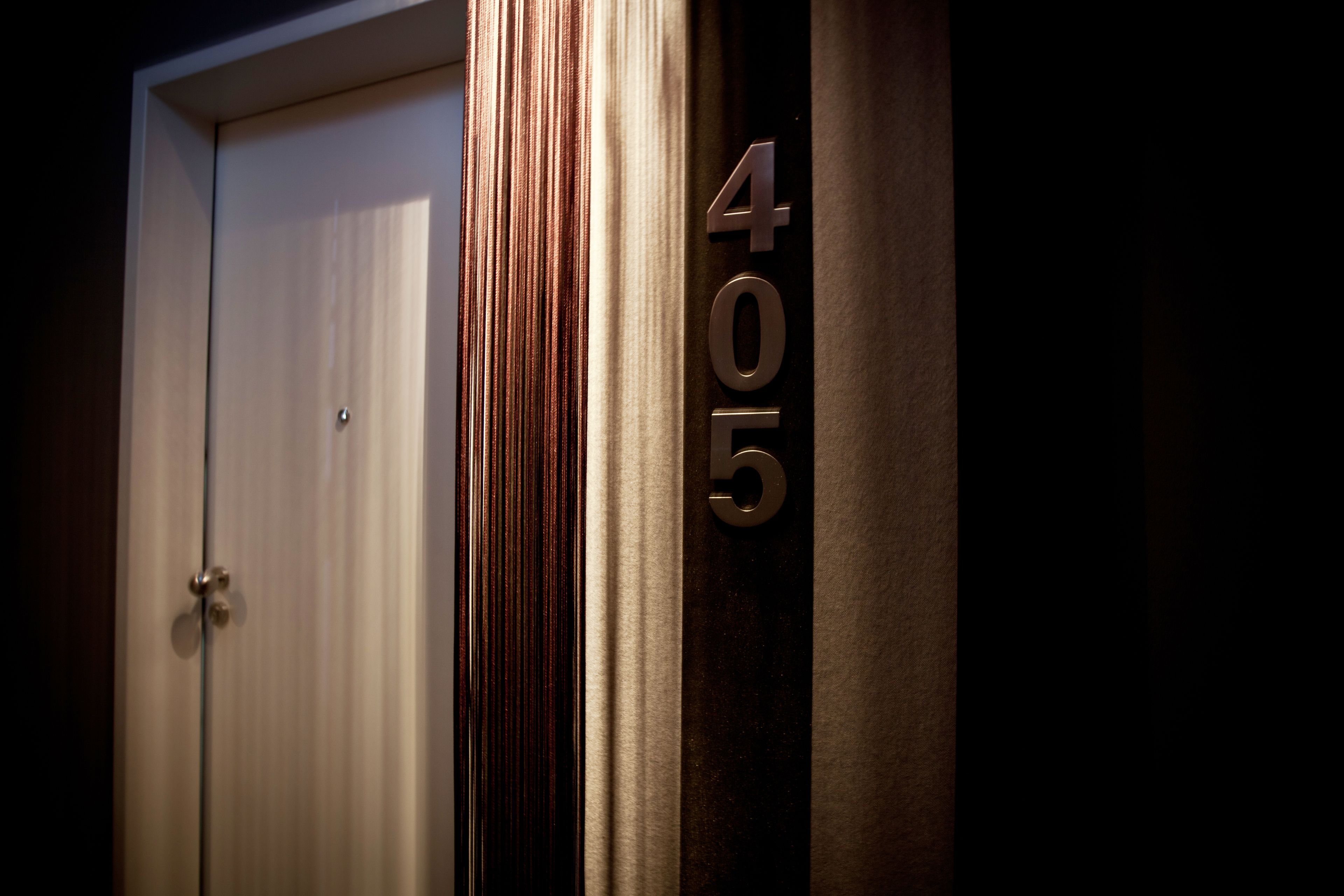 A door with a number "405" on a wall.
