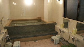 A bathroom with a bathtub, a toilet, a sink, and a mirror. - Business Hotel Wako (Osaka)