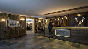 Un área de recepción con un mostrador de madera, obras de arte enmarcadas y un letrero que dice 'Curry'.