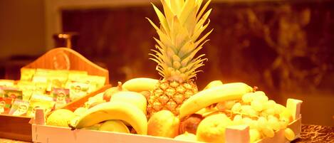 A fruit display with bananas, lemons, and a pineapple.