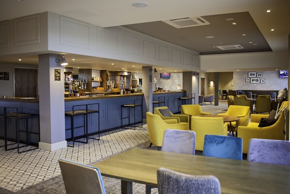 A modern bar area with seating and a counter. - Hilton Southampton - Utilita Bowl (Southampton)