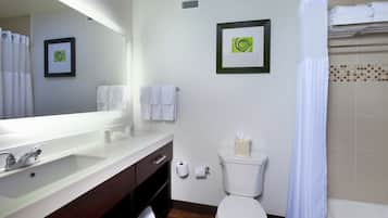 A bathroom with a sink, toilet, and shower.