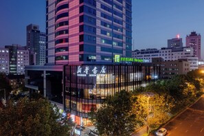 A modern building with a glass facade and signage for a bookstore.