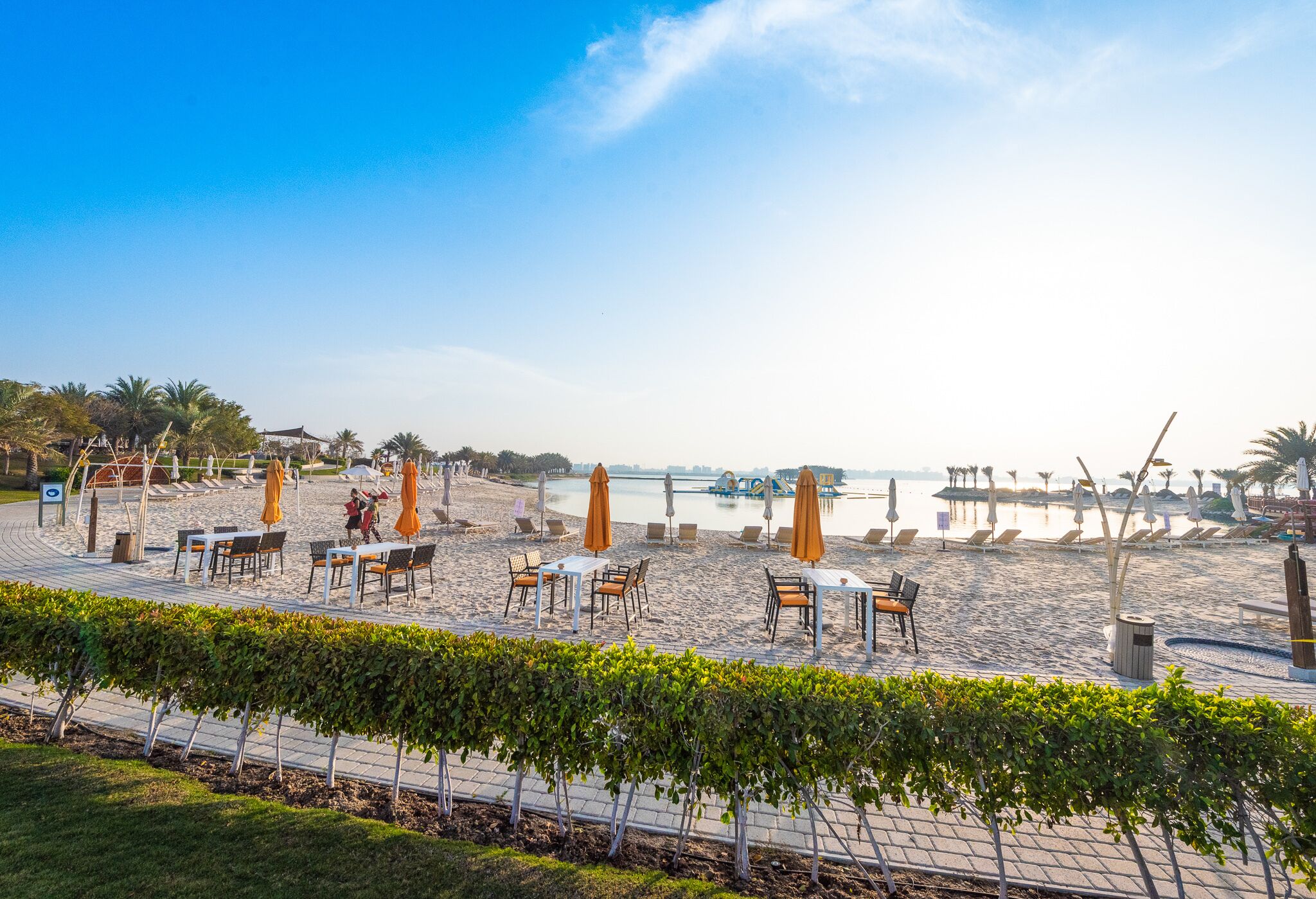 On the beach, white sand, sun loungers, beach umbrellas
