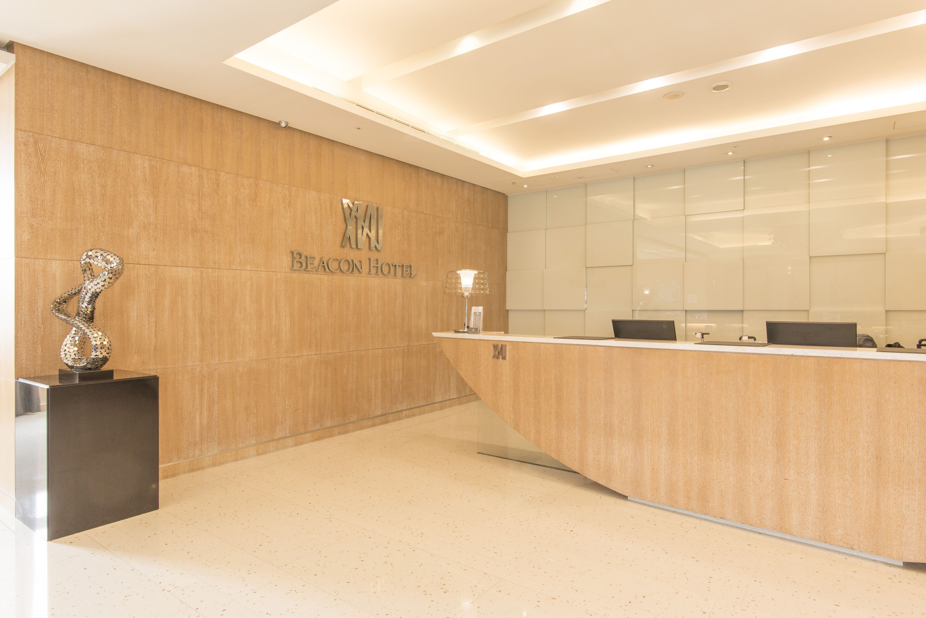 A modern reception area with a wooden wall and a reception desk.