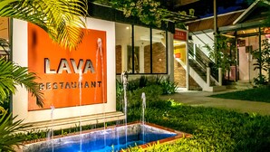 A restaurant named Lava with a signboard, a water feature, and a staircase leading to the entrance. - River and Villa (Siem Reap)