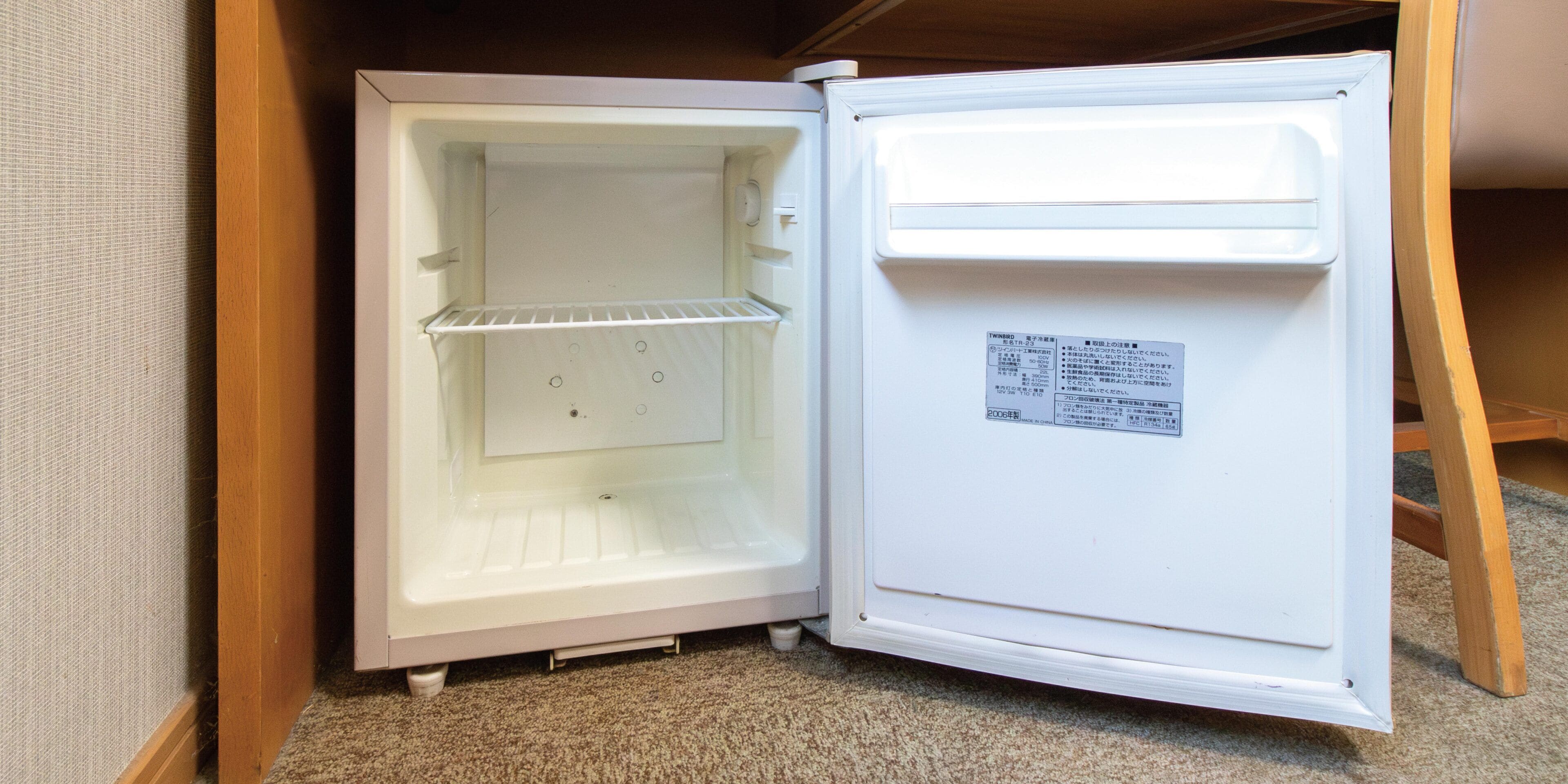 A white refrigerator with a freezer compartment on top and a main compartment below.