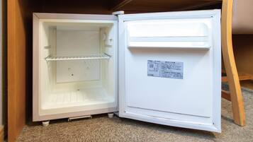 A white refrigerator with a freezer compartment on top and a main compartment below.