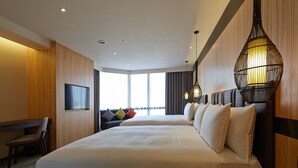 A hotel room with two beds, a desk, a chair, a TV, and a large window with a view. - La Vida Hotel (Taichung)
