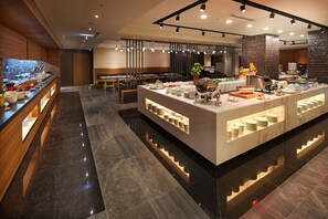 A modern hotel lobby with a marble reception desk, seating area, and a buffet counter. - La Vida Hotel (Taichung)