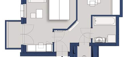Een plattegrond van een hotelkamer met een bed, een badkamer, een zithoek en een kitchenette.