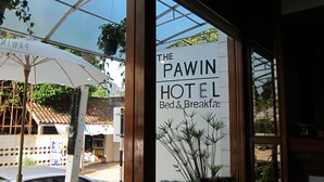 A hotel sign with the name "The Pawin Hotel" and mentions "Bed & Breakfast". - The Pawin (Chiang Mai)