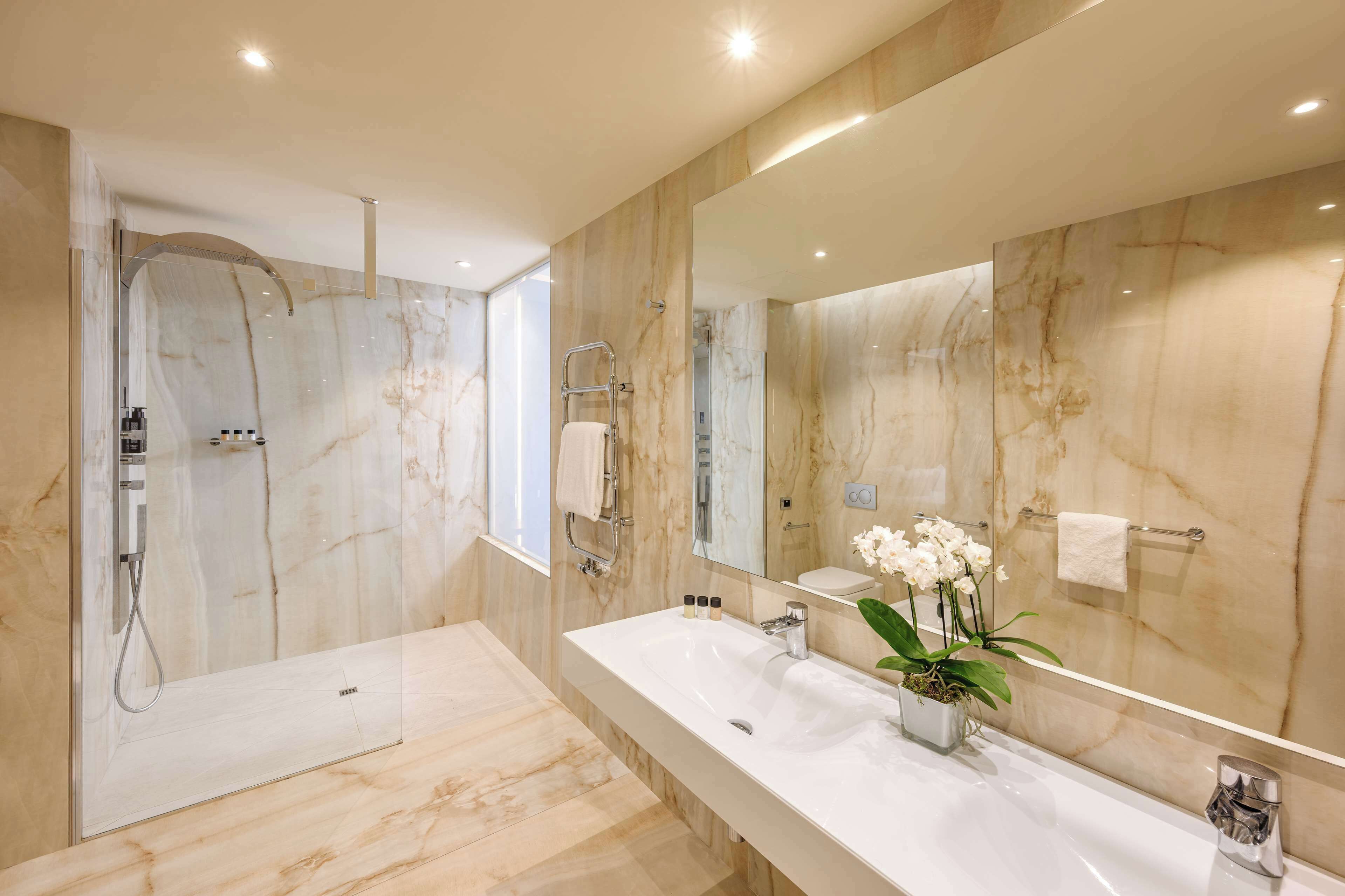 junior suite | bathroom | shower, rainfall showerhead, slippers, towels