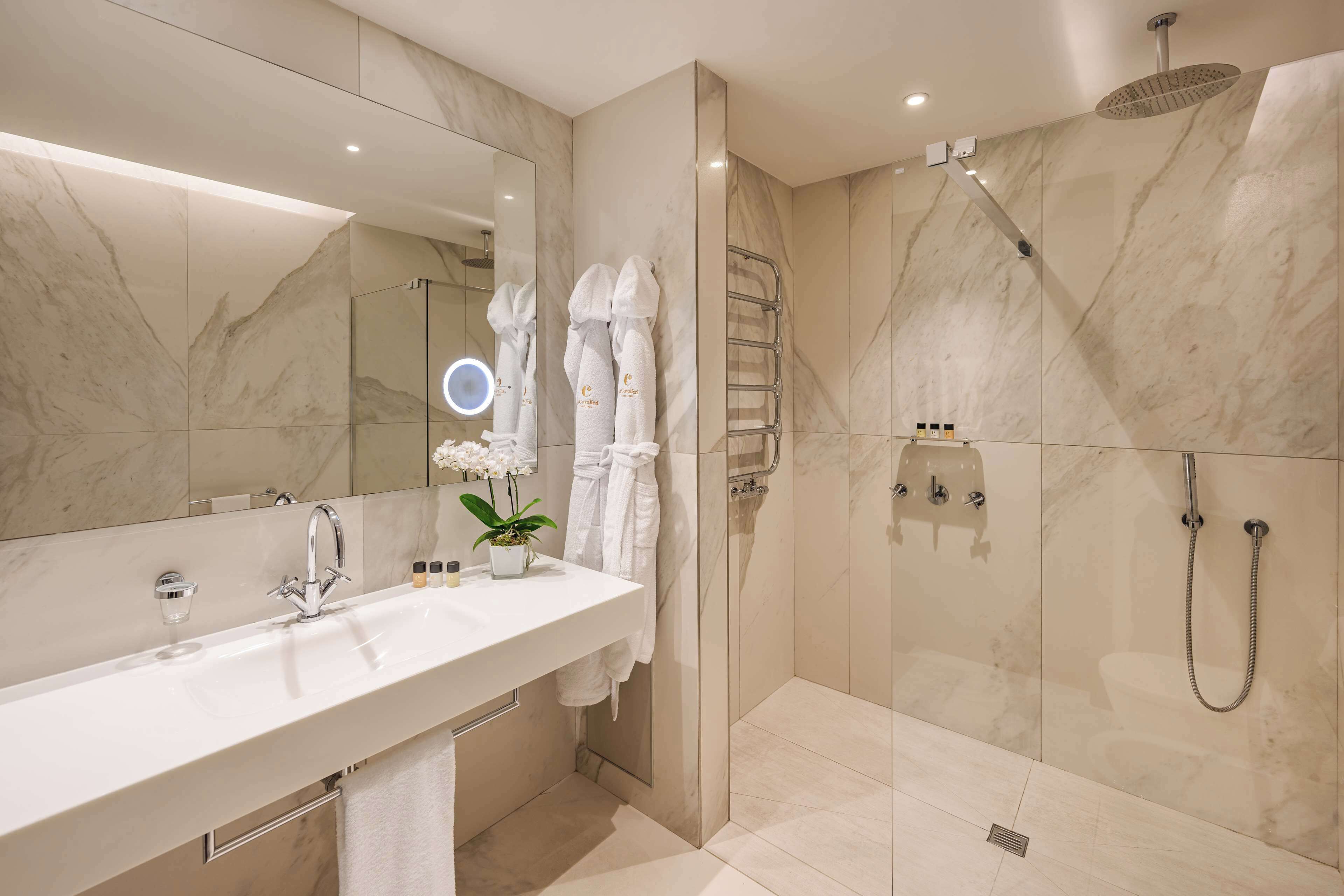 junior suite | bathroom | shower, rainfall showerhead, slippers, towels