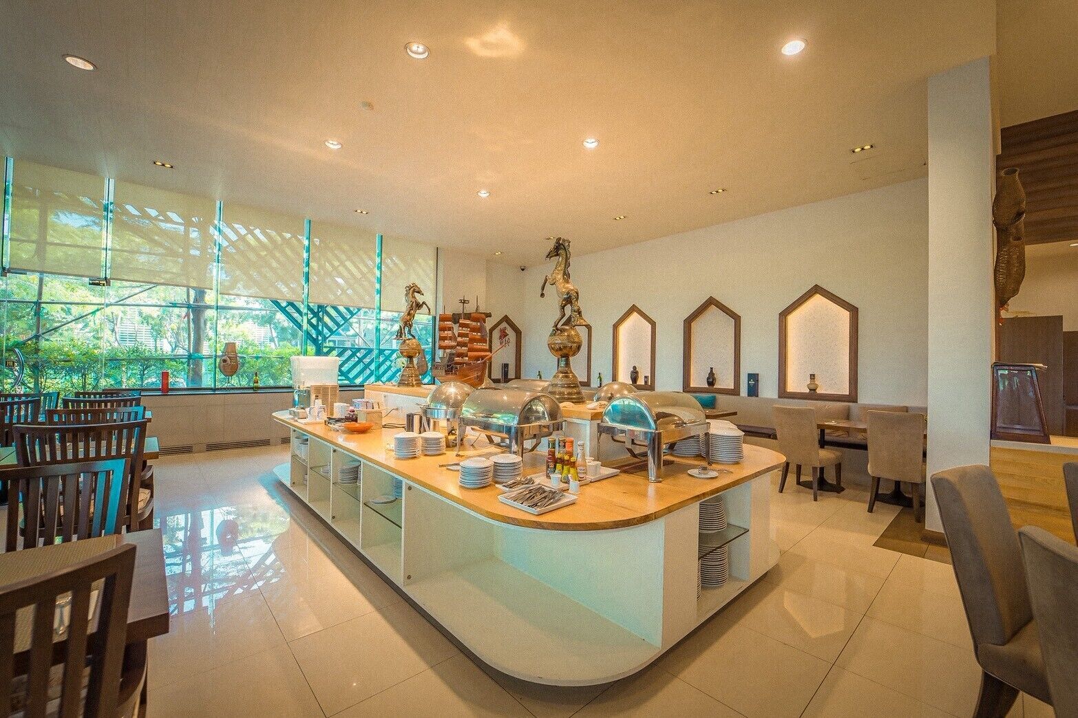 A modern breakfast bar with seating, a buffet setup, and decorative items.