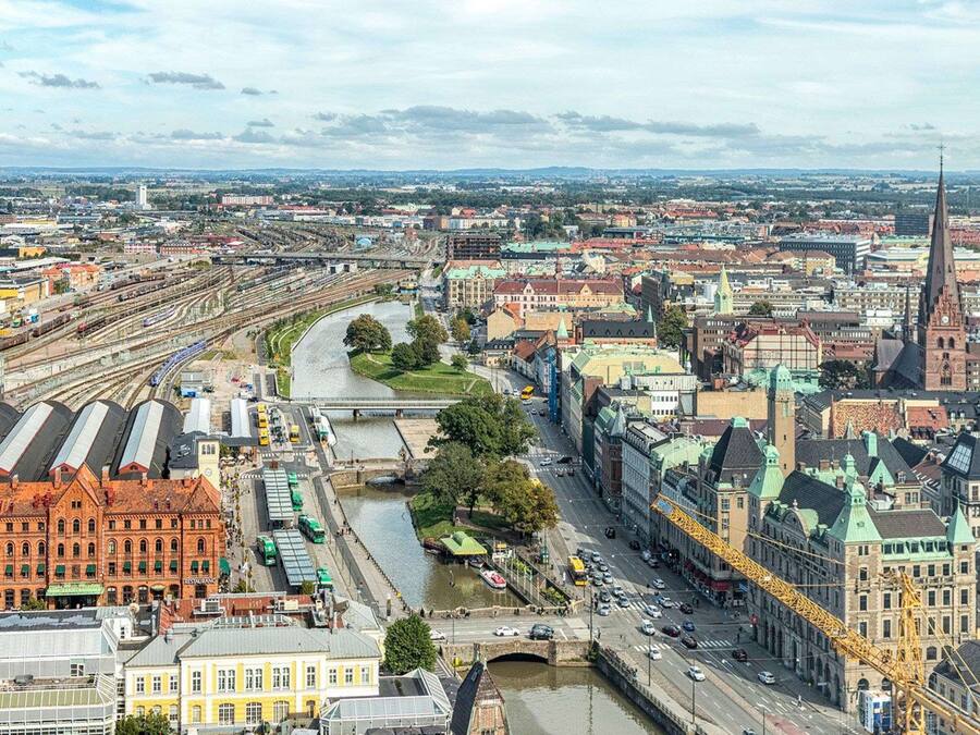 A cityscape with a prominent river, historic buildings, and a modern bridge.
