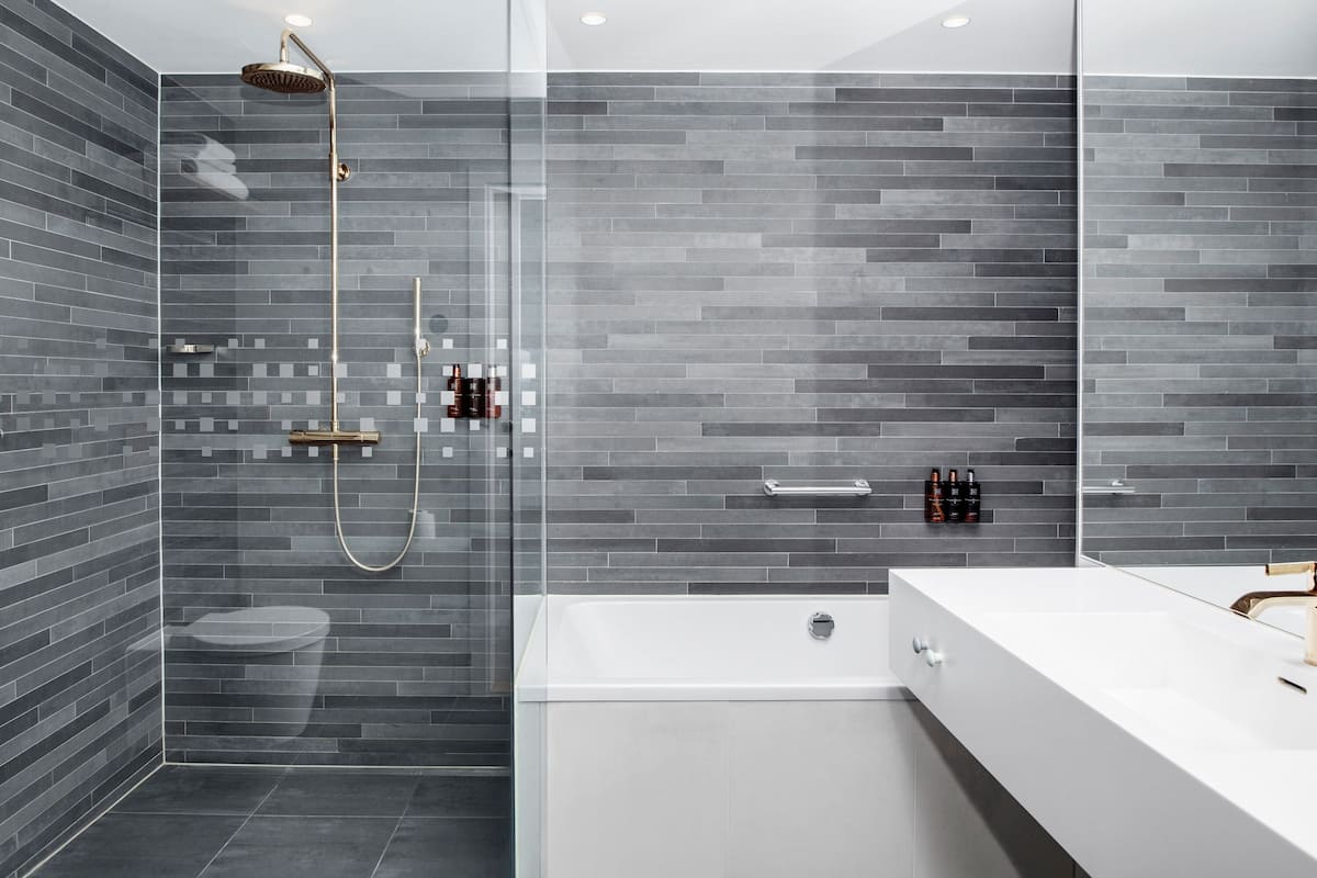 deluxe room, 1 double bed with sofa bed, non smoking | bathroom | hair dryer, towels, soap, shampoo