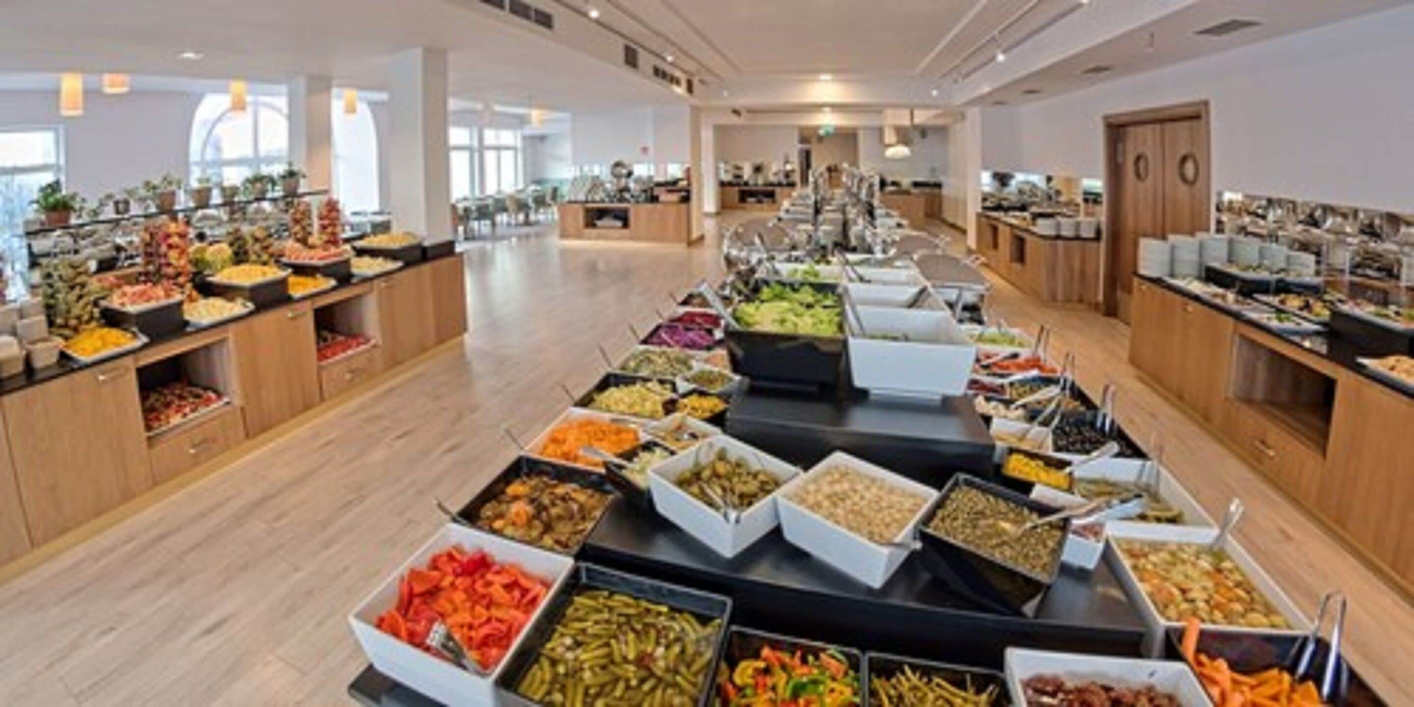 A buffet with various food options arranged on tables.