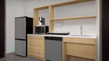 A compact kitchen with a refrigerator, microwave, dishwasher, and a sink.