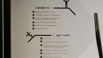 A set of gym rules displayed on a wall, including guidelines on attire, equipment use, and safety.