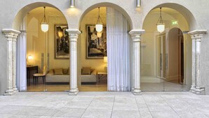 A hotel entrance with three arched doorways, each with a hanging light fixture. - Santiago de Alfama - Boutique Hotel (Lisbon)