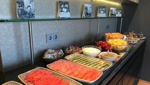 A buffet with various food items including sliced vegetables, fruits, and dips. - Hótel Ísafjörður (Isafjordur)