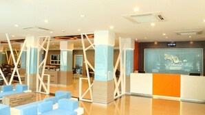 A modern hotel lobby with seating areas, a reception desk, and a visible restaurant sign. - Chariot Pattaya Residence (Pattaya)
