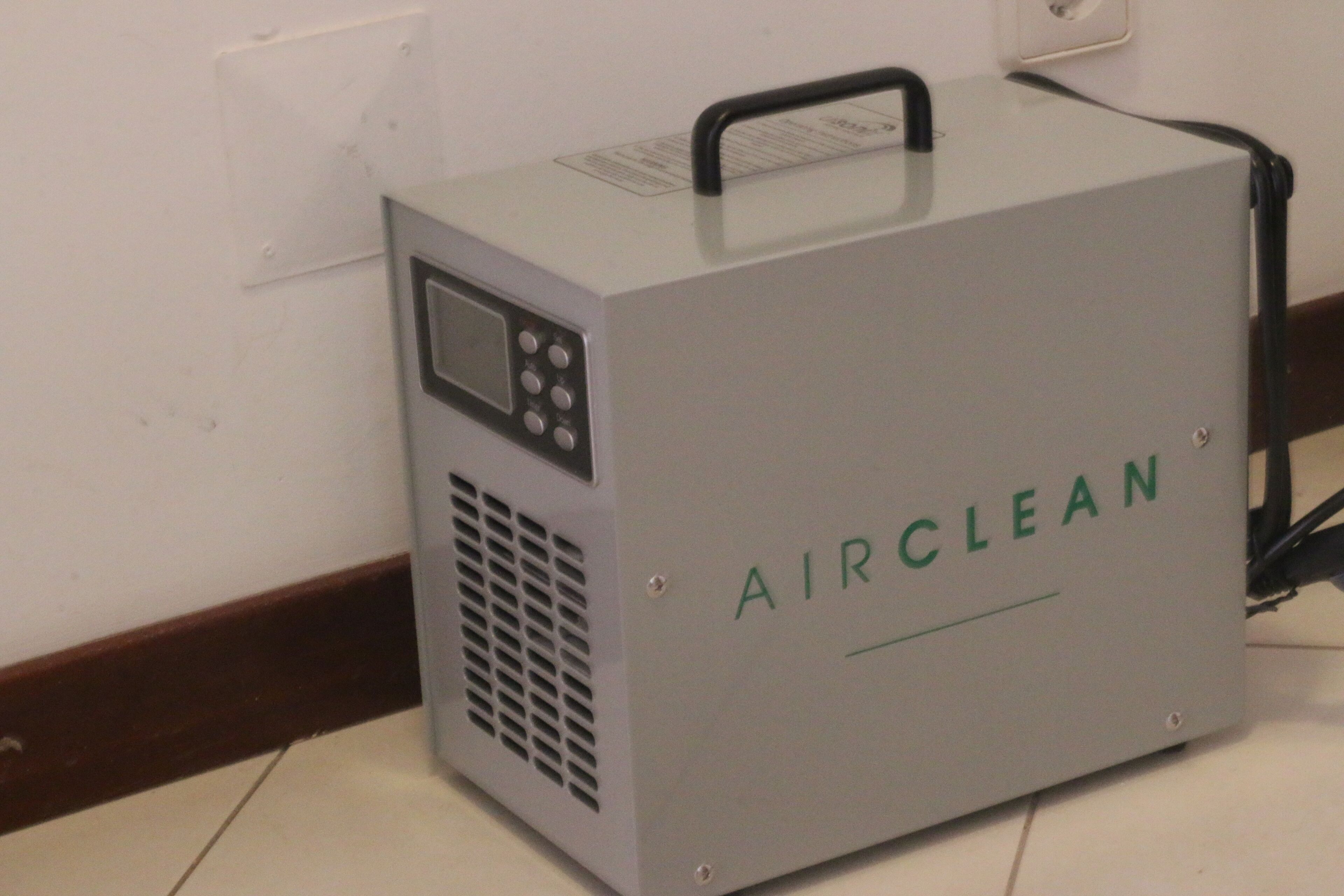 A portable air cleaner labeled "AIRCLEAN" with a control panel and a handle on top.