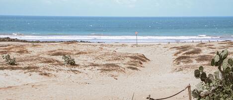 On the beach, white sand, beach umbrellas, beach towels