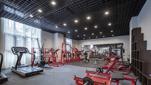 A spacious gym with treadmills, weight machines, and free weights. - Holiday Inn Express Shanghai New Jinqiao by IHG (Shanghai)